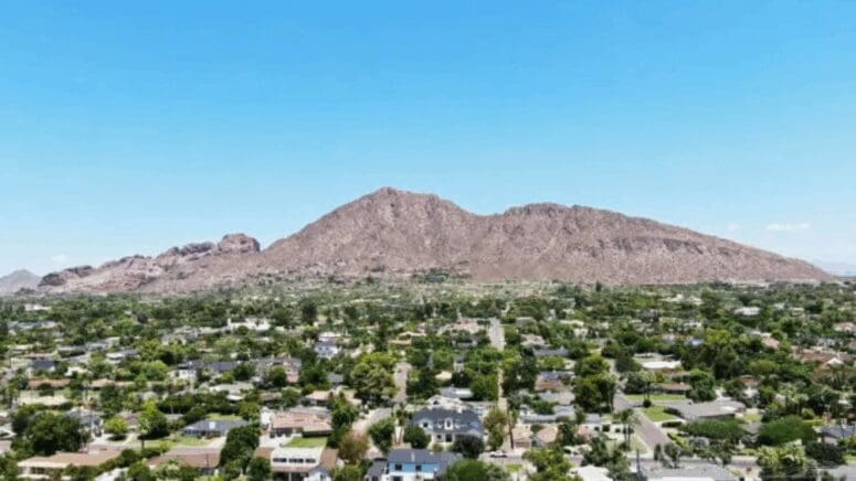 A view of Camelback Mountain and the suburban neighborhoods below it from an elevated vantage point.
