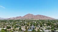 A view of Camelback Mountain and the suburban neighborhoods below it from an elevated vantage point.