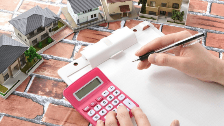 A person calculating house value.