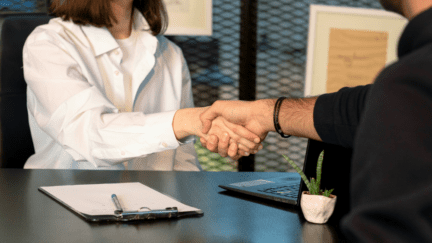 An image of a handshake over a buyer broker agreement