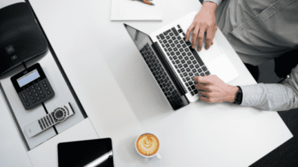 Image of individual using his laptop to search for top realtors