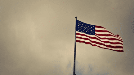 An American flag near a home sold by a military relocation professional.