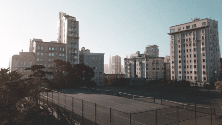 A condo building with a tennis court that has an HOA.